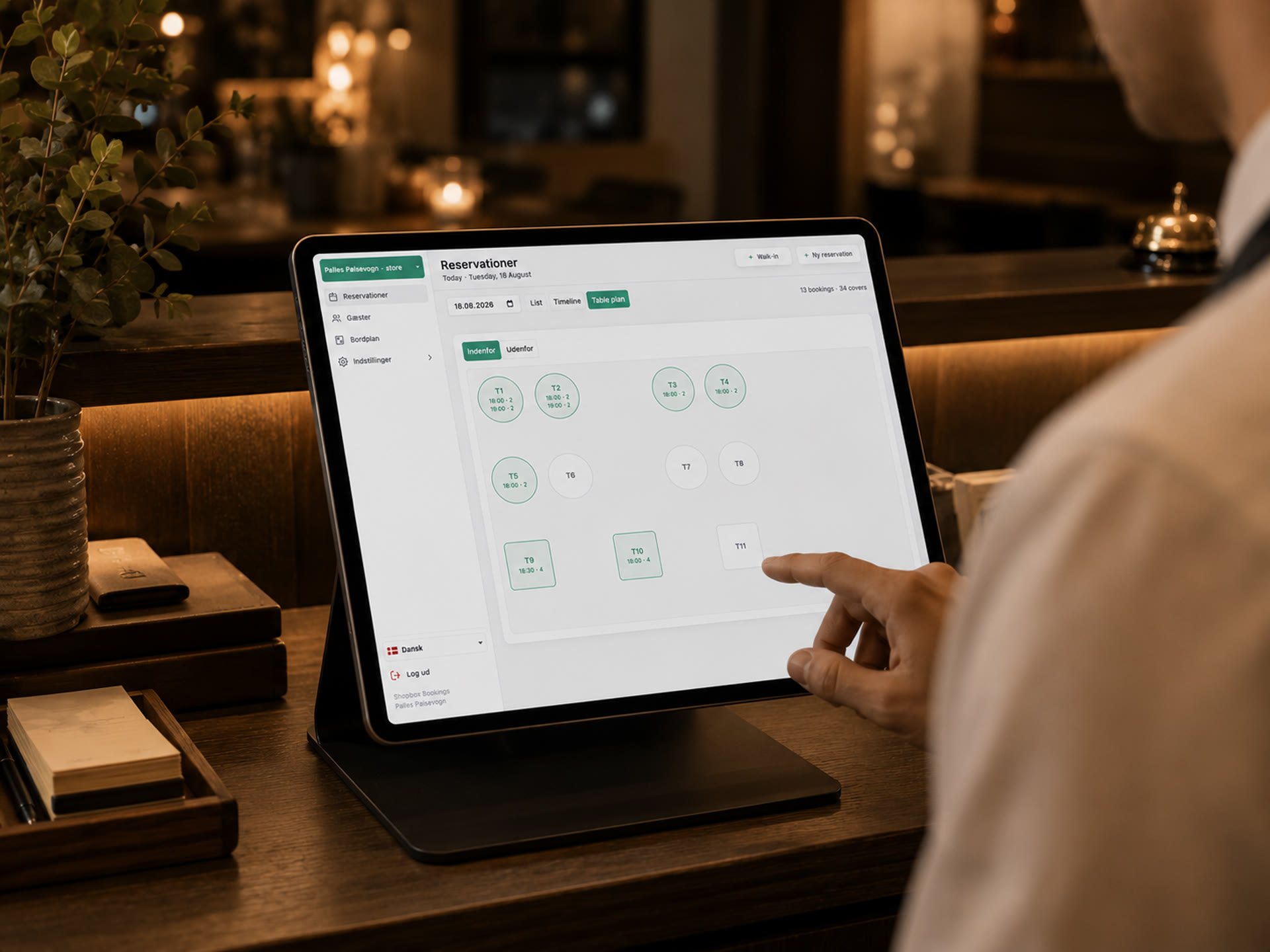 Shopbox Bookings' table plan on a tablet at a restaurant table